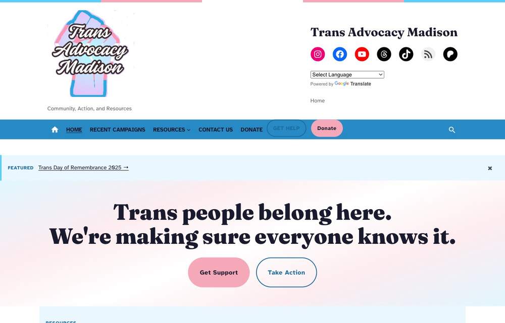 Trans Advocacy Madison homepage with a trans-flag color band at the top and a serif hero headline reading Trans people belong here. We're making sure everyone knows it.
